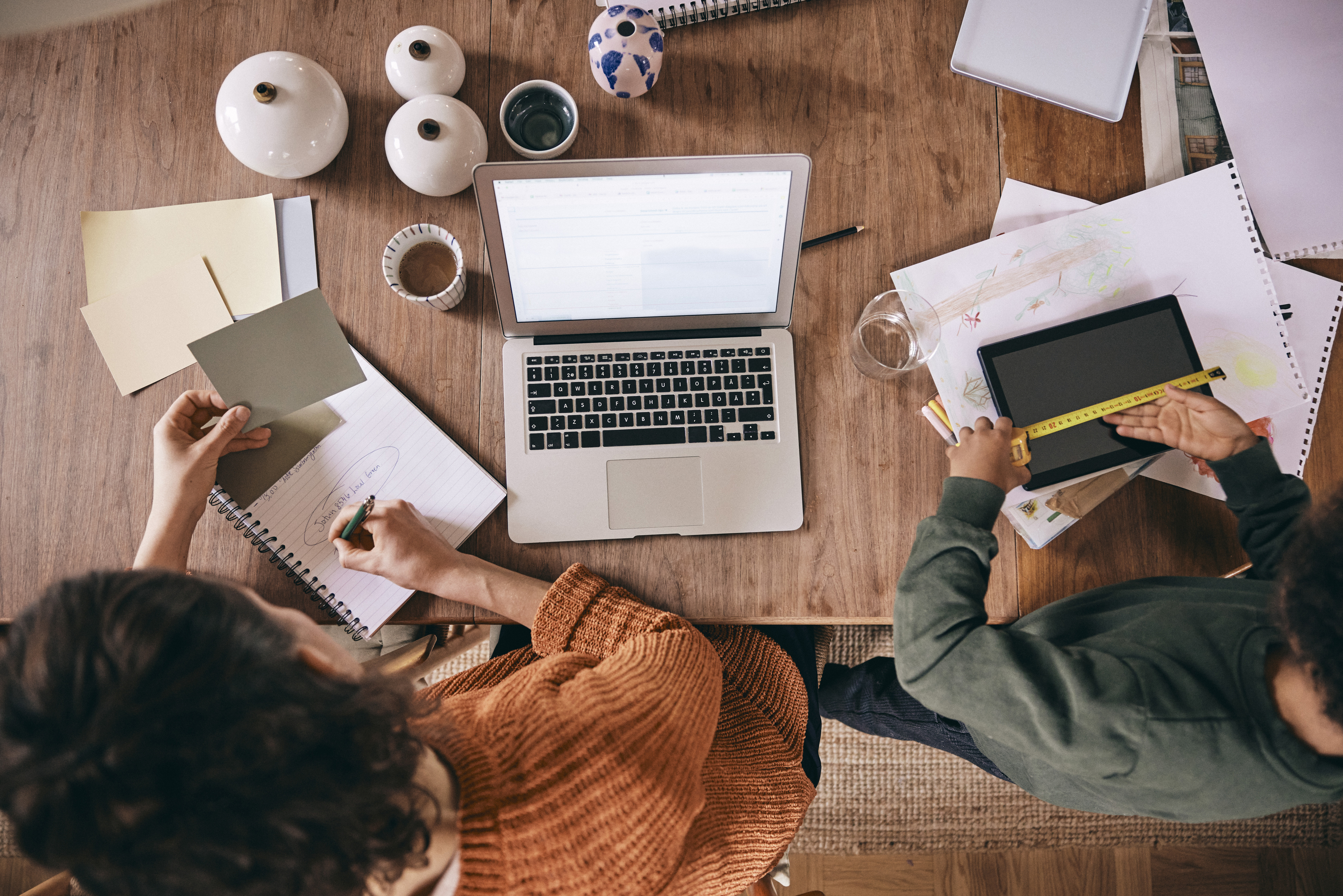 Two people working in front of the computer together